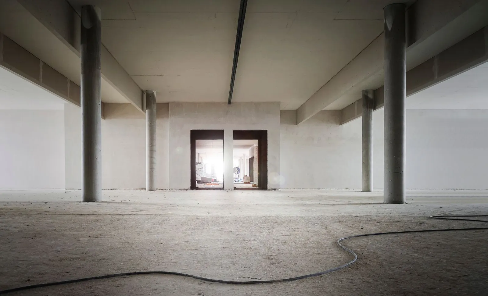 Open commercial shell space with concrete columns awaiting tenant improvement